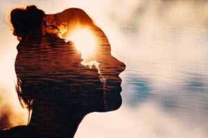 Sun peeks out from behind the clouds in woman’s head Sun peeks out from behind the clouds in woman’s head