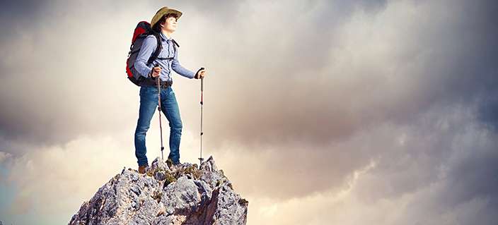 Young tourist atop of mountain